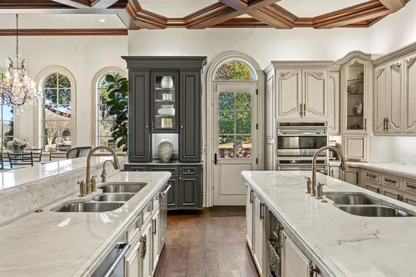 a kitchen with stainless steel appliances granite countertop a sink stove and cabinets