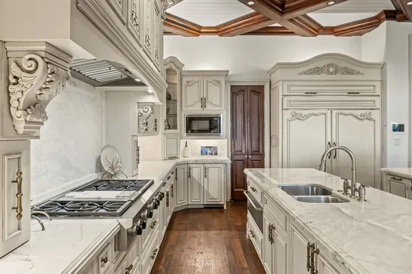 a kitchen with stainless steel appliances granite countertop a stove and a sink