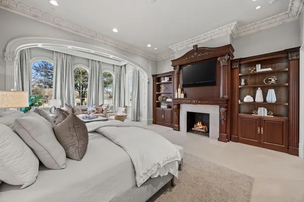 a spacious bedroom with a balcony a bed and a television