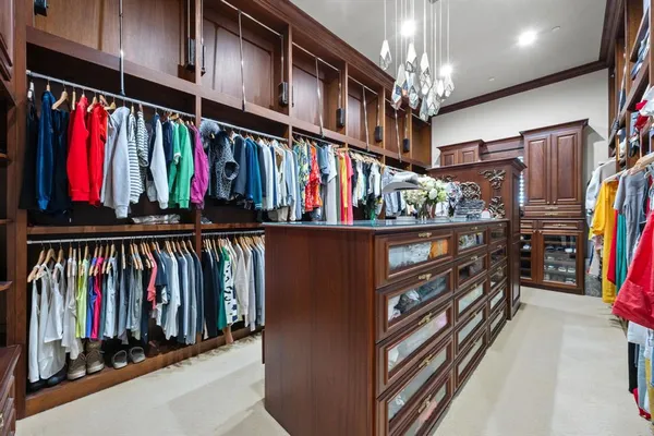 a view of walk in closet with clothes