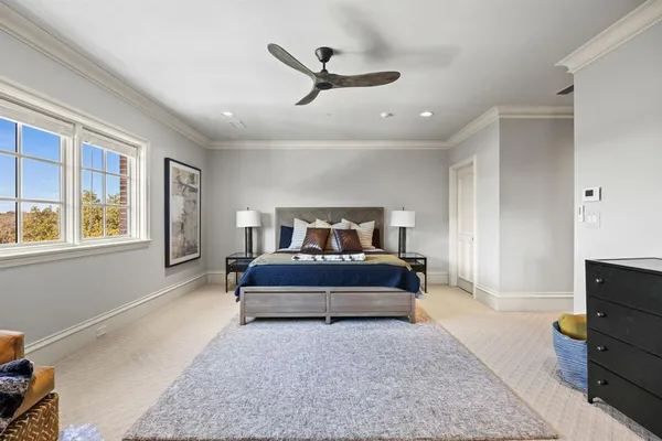 a spacious bedroom with a bed and window