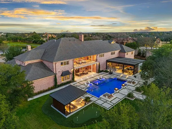 an aerial view of a house with a big yard