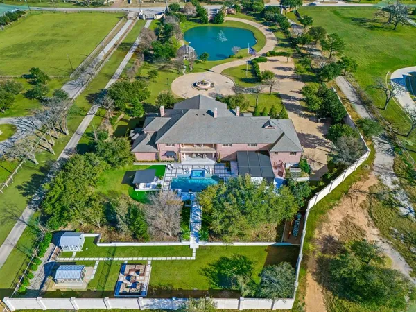 an aerial view of a house with a garden and lake view