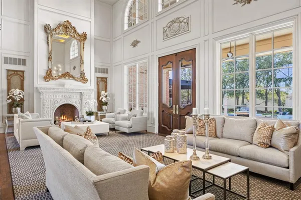 a living room with furniture fireplace and a large window
