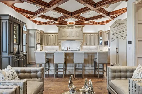 a living room with furniture and kitchen view