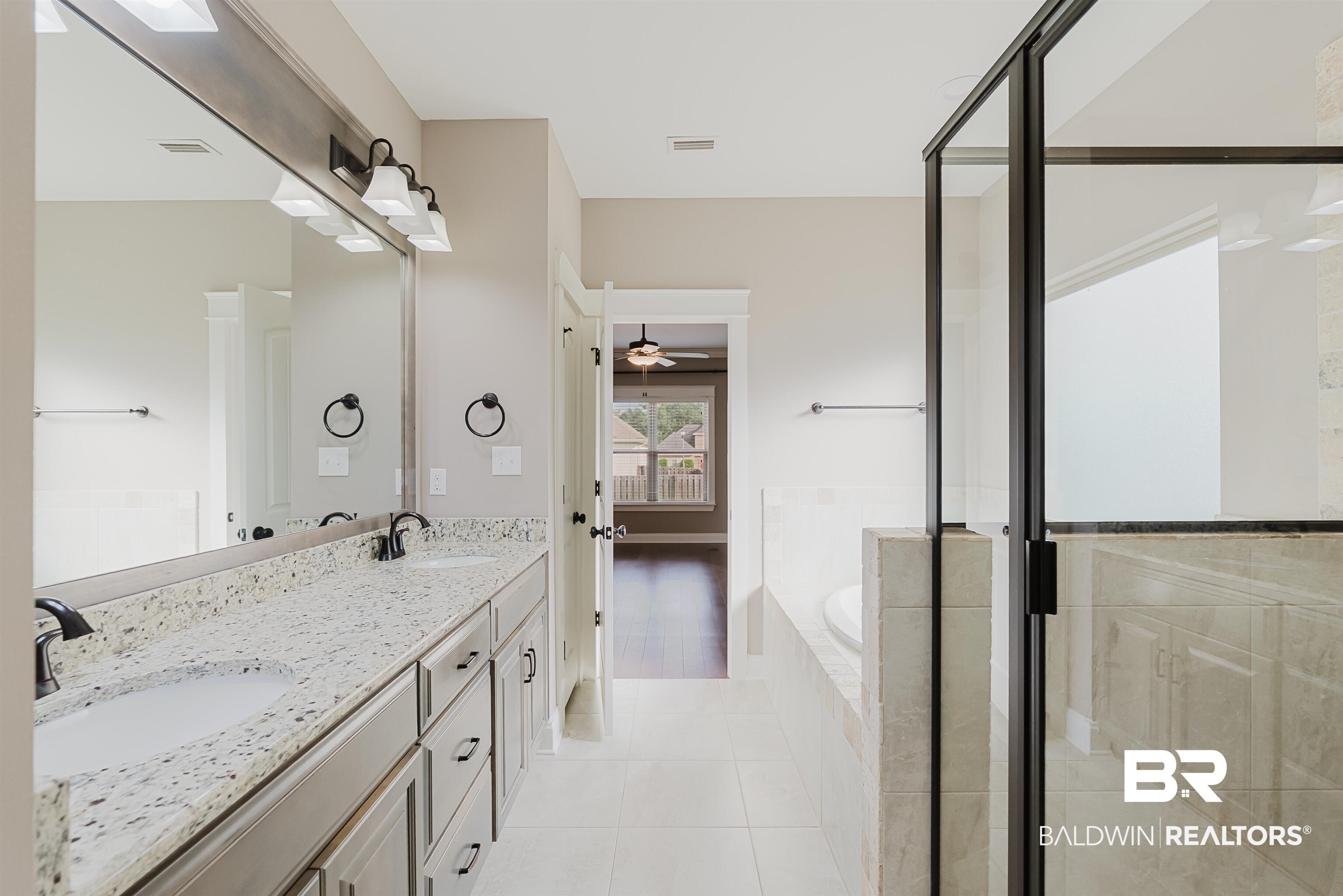 237 Hawthorne Circle Fairhope, AL 36532 - Photo 7 of 14 Bathroom with a bath, double vanity, light tile patterned floors, a stall shower, and ceiling fan