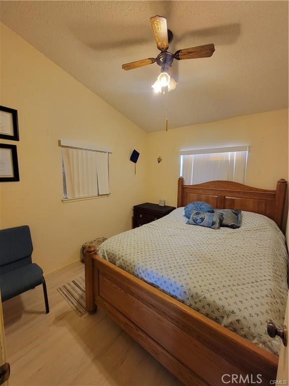 5566 Oleta Road Landers, CA 92285 - Photo 11 of 21 a bedroom with a bed and a chandelier