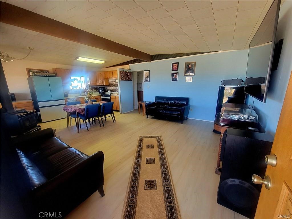 5566 Oleta Road Landers, CA 92285 - Photo 3 of 21 a living room with furniture and a wooden floor