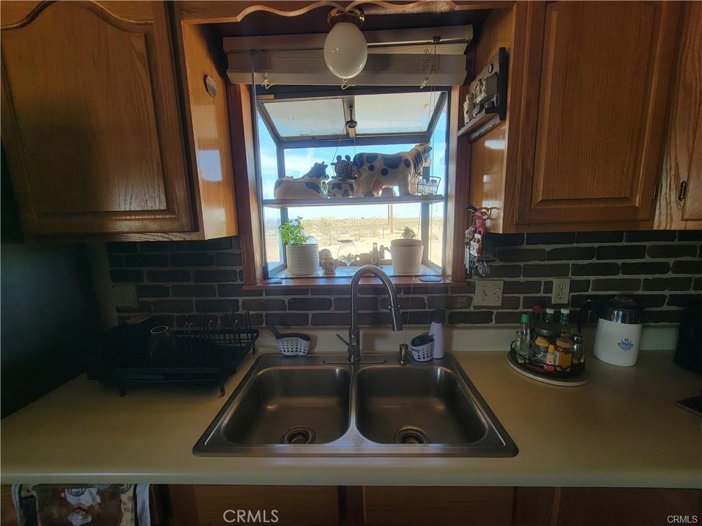 5566 Oleta Road Landers, CA 92285 - Photo 7 of 21 a kitchen with a sink and cabinets