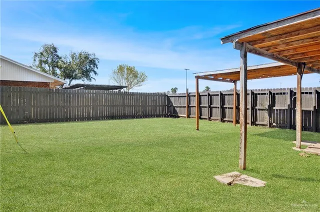 a view of a backyard with a garden and entertaining space
