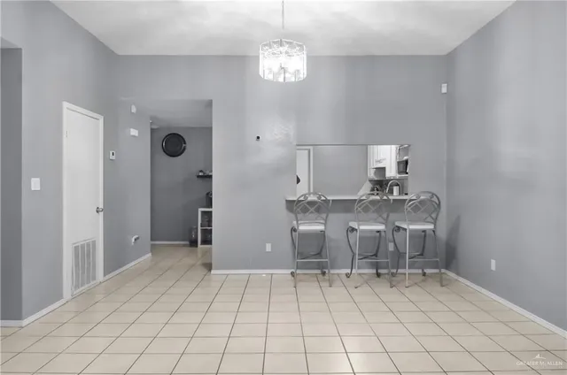 a view of kitchen with windows cabinet and refrigerator