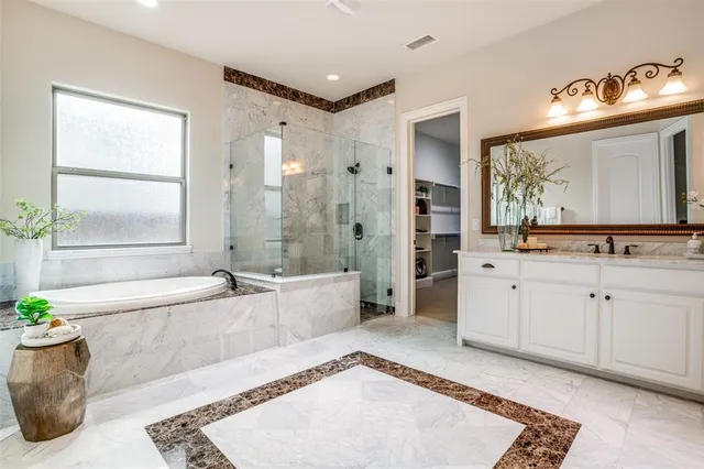a spacious bathroom with a tub sink and mirror