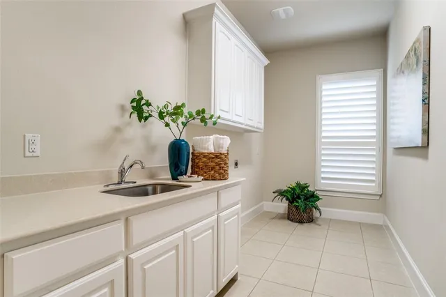 a white vase with flowers