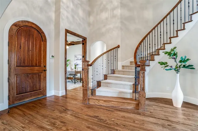 a view of staircase with wooden floor and a potted plant
