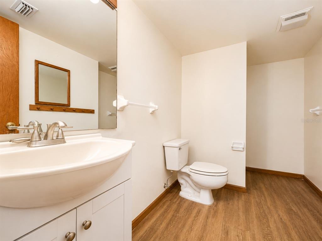 7119 Immokalee Road Keystone Heights, FL 32656 - Photo 38 of 50 a bathroom with a sink toilet and a mirror