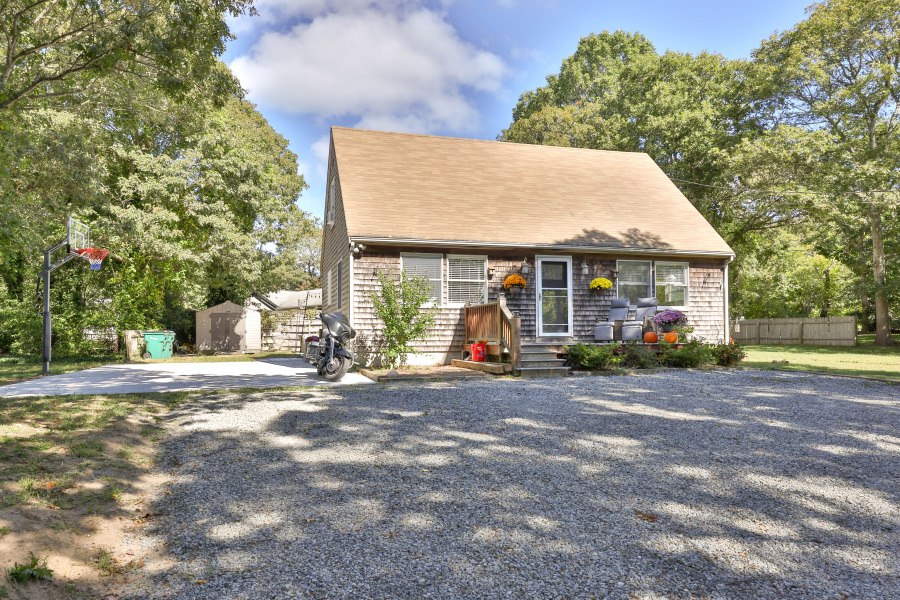 a view of a house next to a yard with road