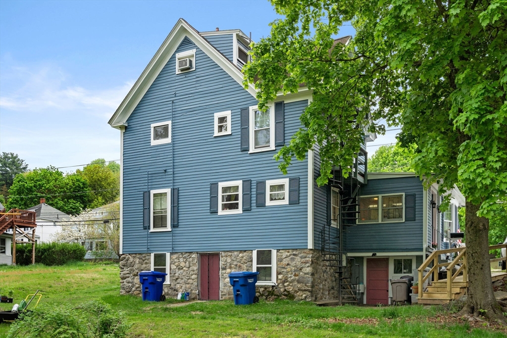 26 Powder Mill Road Maynard, MA 01754 - Photo 10 of 16 a front view of a house with garden