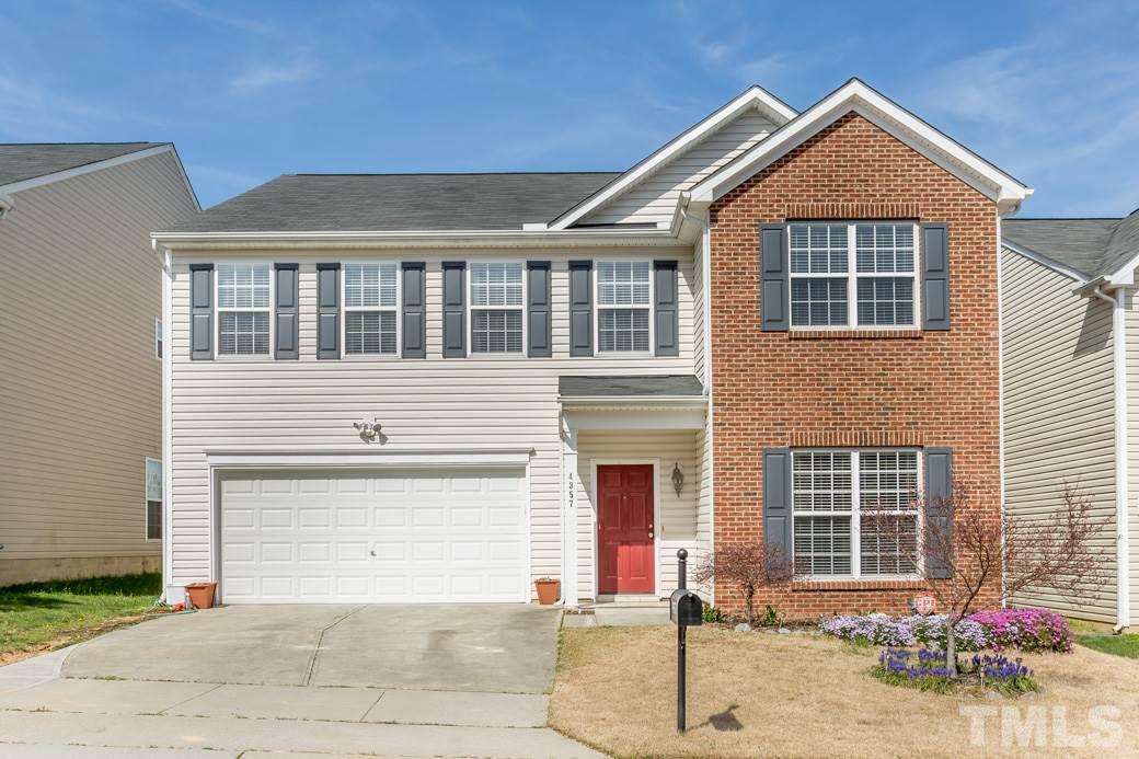 4357 Karlbrook Lane Raleigh, NC 27616 - Photo 1 of 25 a front view of a house with a yard and garage