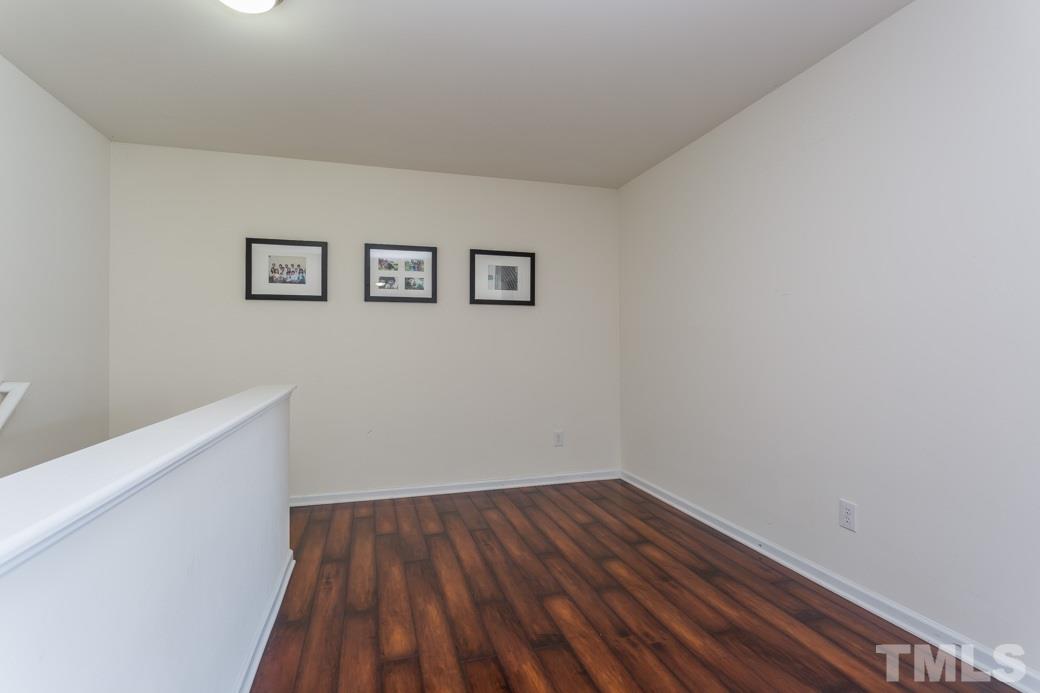 4357 Karlbrook Lane Raleigh, NC 27616 - Photo 14 of 25 a view of a hallway with wooden floor