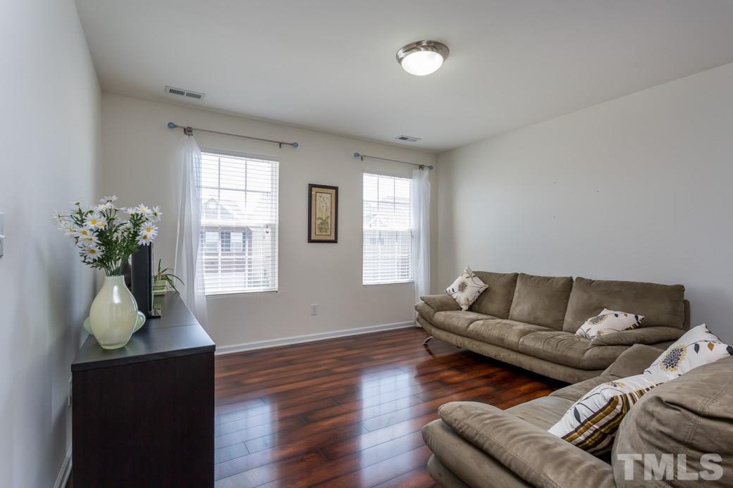 4357 Karlbrook Lane Raleigh, NC 27616 - Photo 15 of 25 a living room with furniture and a potted plant