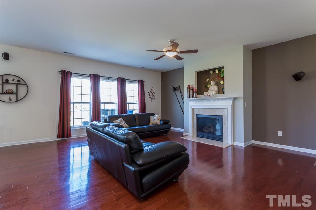 4357 Karlbrook Lane Raleigh, NC 27616 - Photo 6 of 25 a living room with furniture and a fireplace