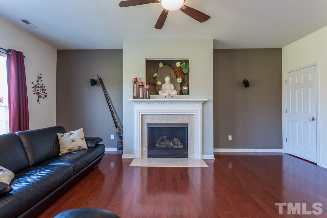 4357 Karlbrook Lane Raleigh, NC 27616 - Photo 8 of 25 a living room with furniture and a fireplace