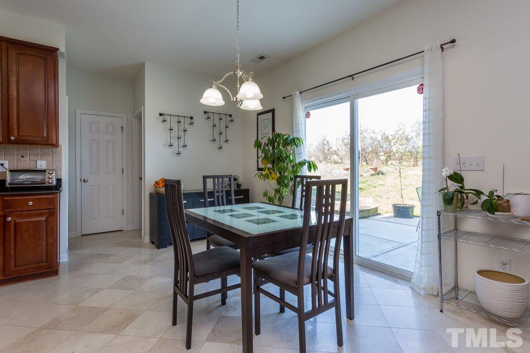 4357 Karlbrook Lane Raleigh, NC 27616 - Photo 9 of 25 a view of a dining room with furniture window and outside view