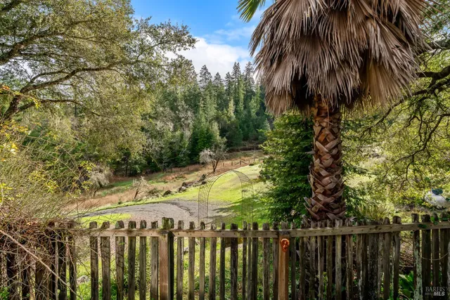 a view of a balcony with wooden floor and fence