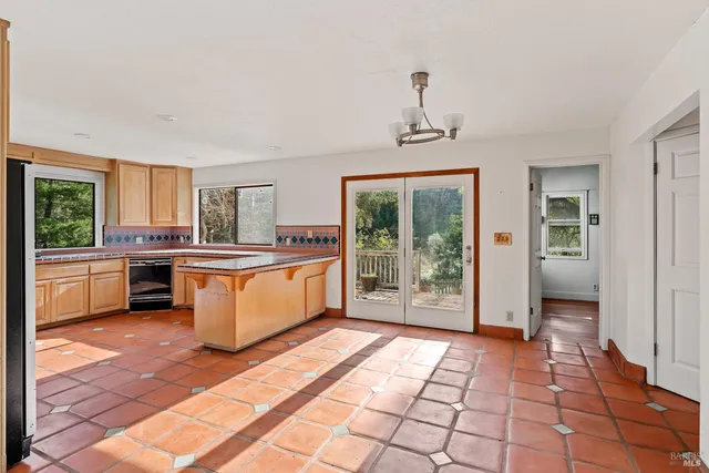 a view of a kitchen with a sink and windows