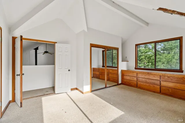 a large bedroom with a large bed and large window