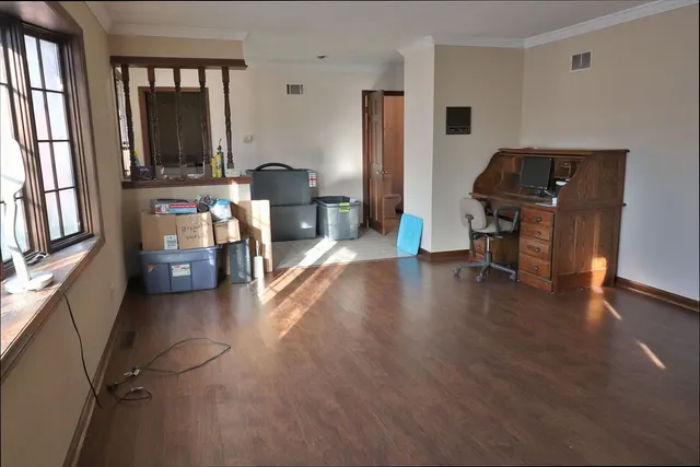 a view of a workspace with furniture and a window