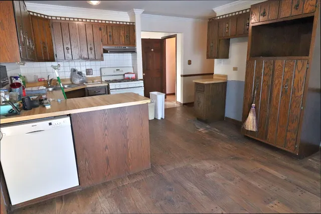 a kitchen with granite countertop wooden cabinets and a counter top space