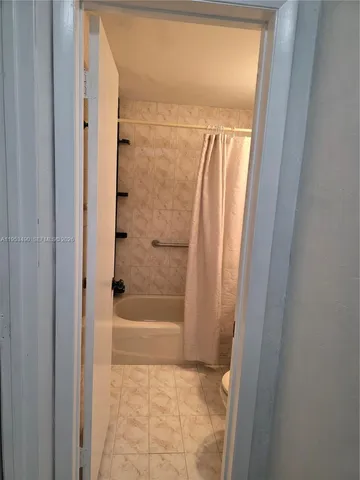 a bathroom with a sink a toilet a mirror and shower