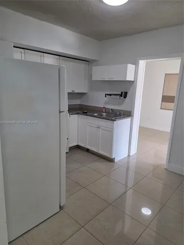 a kitchen with stainless steel appliances granite countertop a sink and a stove