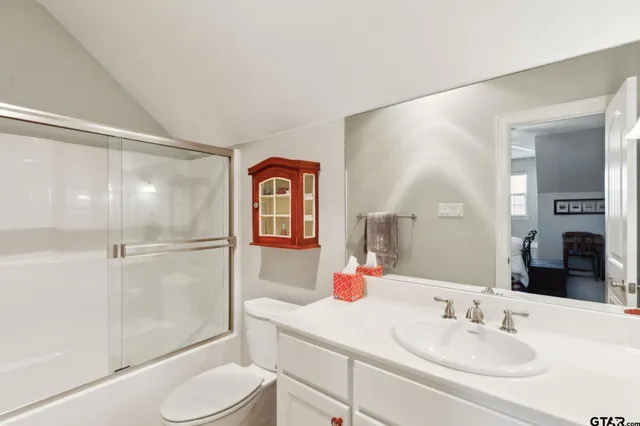 a view of a house with a big yard and large trees