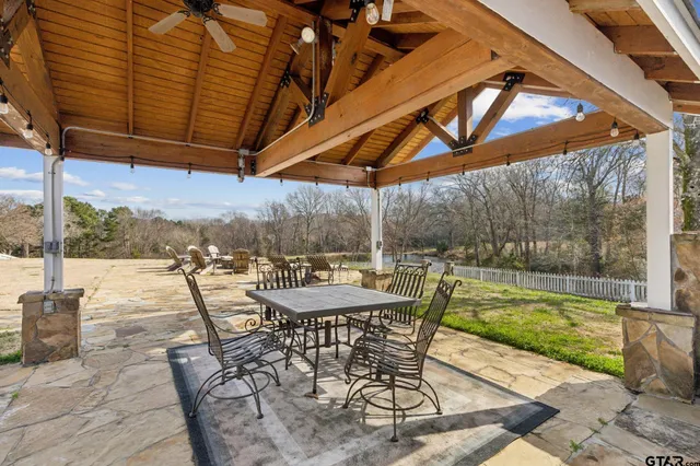 a view of swimming pool with table and chairs
