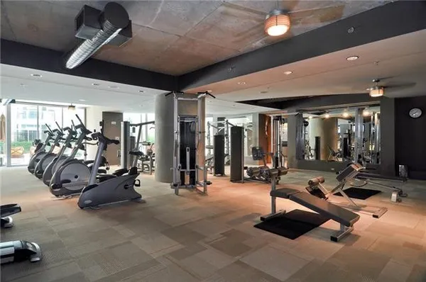a living room with fireplace furniture and a large window