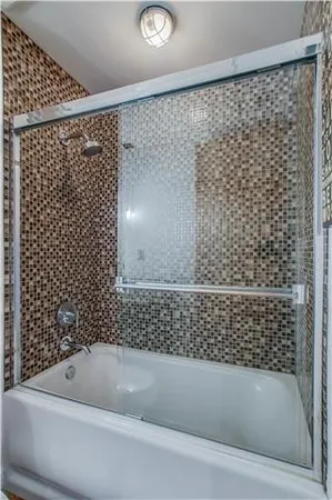 a bathroom with a bathtub and shower