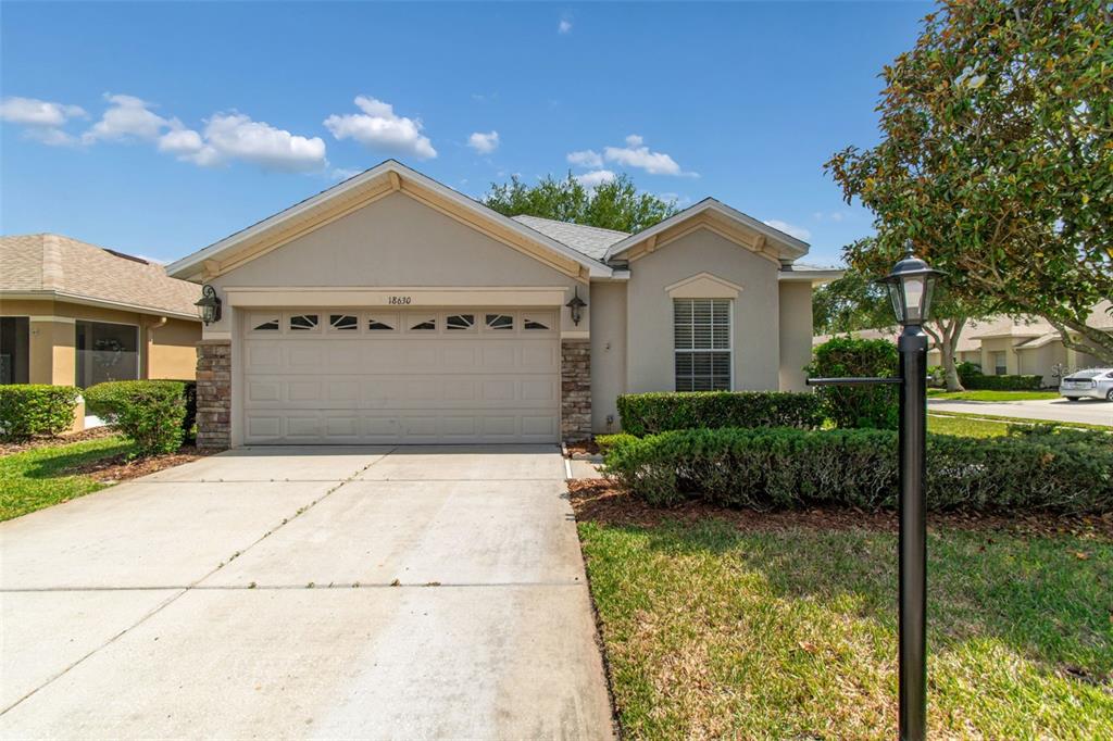 18630 Rolling Hills Loop Hudson, FL 34667 - Photo 1 of 64 a front view of a house with a garden