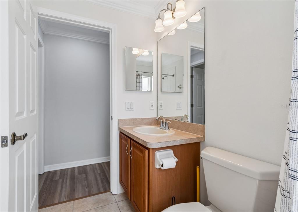 18630 Rolling Hills Loop Hudson, FL 34667 - Photo 11 of 64 a bathroom with a granite countertop toilet a sink and a mirror