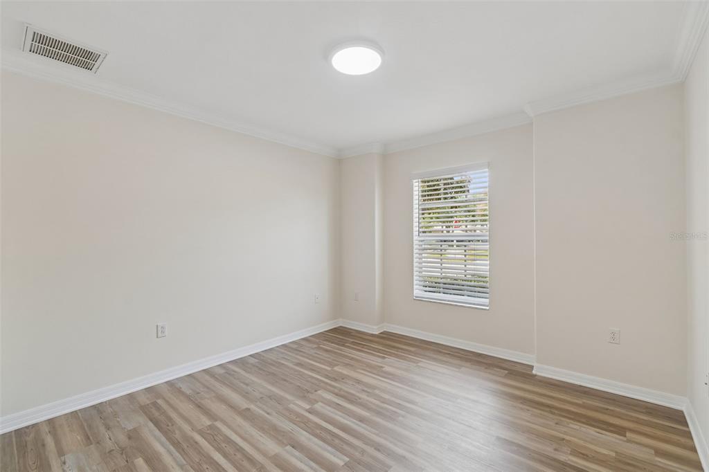 18630 Rolling Hills Loop Hudson, FL 34667 - Photo 13 of 64 a view of an empty room with wooden floor and a window