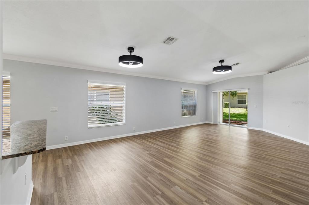 18630 Rolling Hills Loop Hudson, FL 34667 - Photo 14 of 64 a view of an empty room with wooden floor and a window