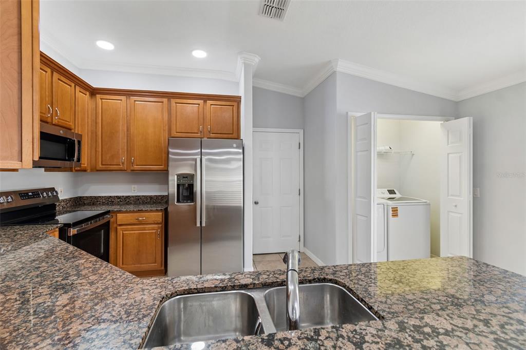 18630 Rolling Hills Loop Hudson, FL 34667 - Photo 20 of 64 a kitchen with a sink a stove and refrigerator