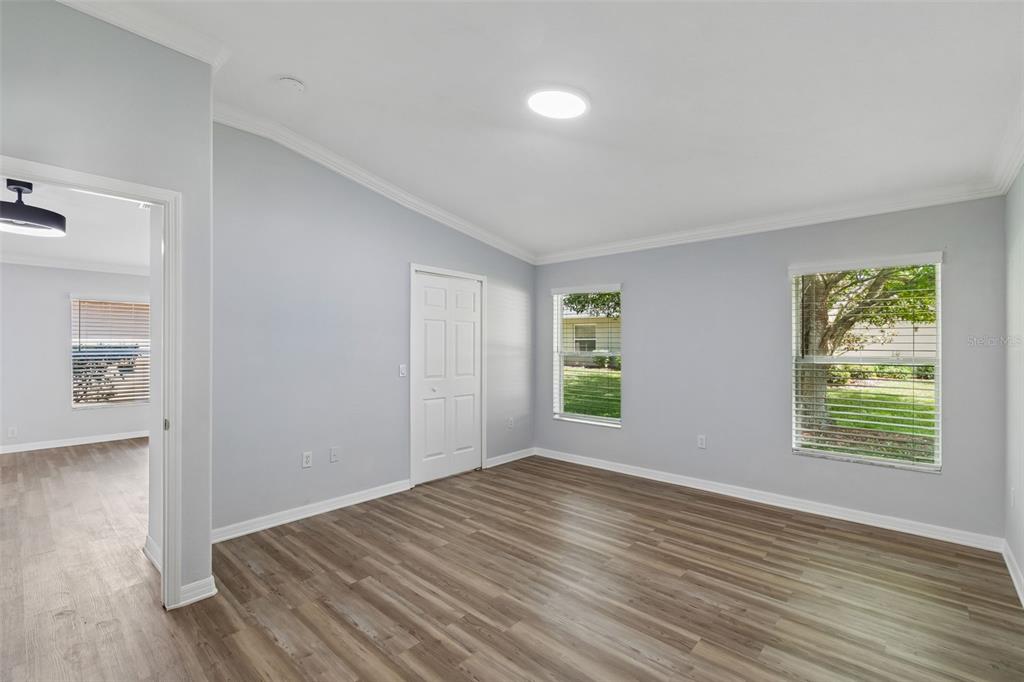 18630 Rolling Hills Loop Hudson, FL 34667 - Photo 25 of 64 an empty room with wooden floor and windows