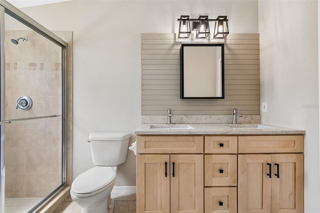 18630 Rolling Hills Loop Hudson, FL 34667 - Photo 28 of 64 a bathroom with a toilet sink vanity and mirror