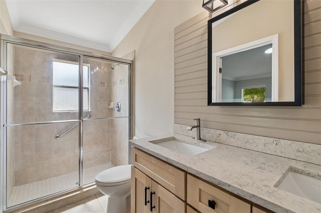 18630 Rolling Hills Loop Hudson, FL 34667 - Photo 29 of 64 a bathroom with a granite countertop sink toilet and shower