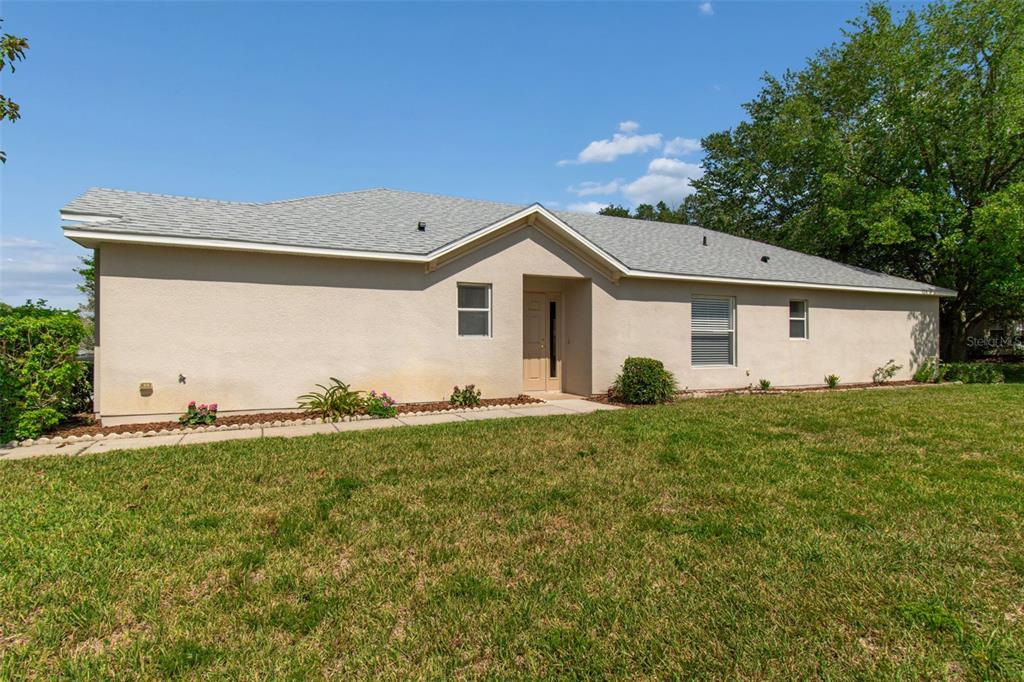 18630 Rolling Hills Loop Hudson, FL 34667 - Photo 3 of 64 a view of a house with a yard