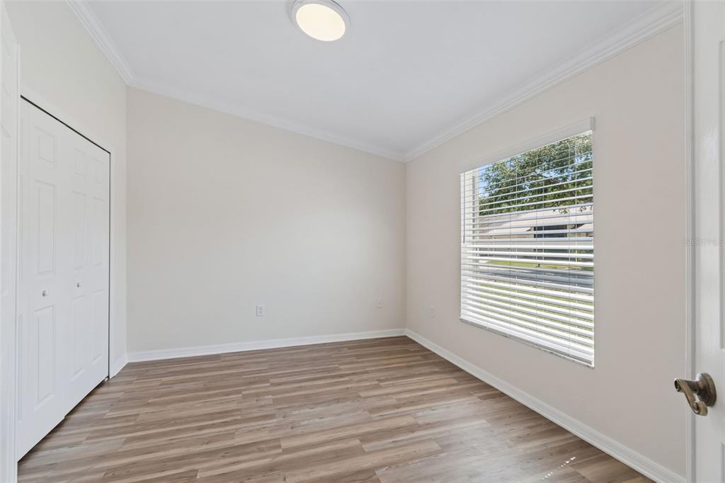 18630 Rolling Hills Loop Hudson, FL 34667 - Photo 8 of 64 a view of an empty room with wooden floor and a window