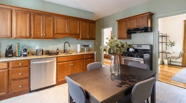 a kitchen with a sink refrigerator and cabinets