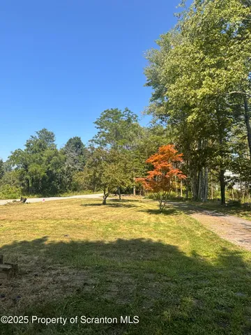 a view of backyard with a garden and deck